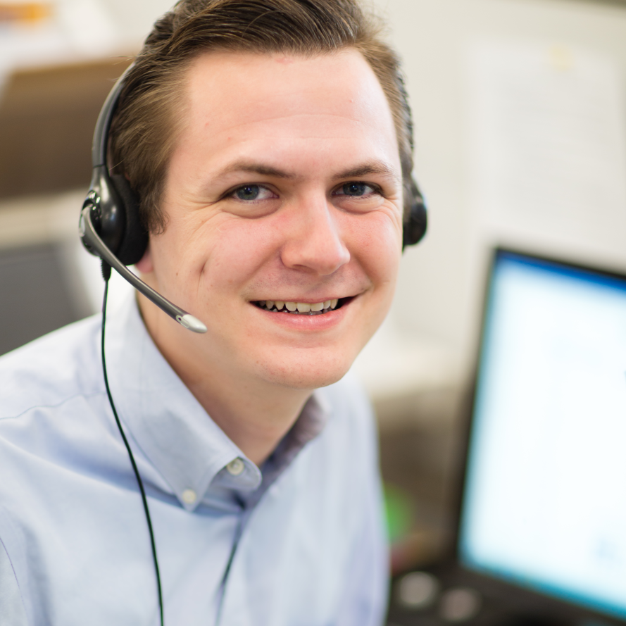 211 operator wearing telephone headset, smiling