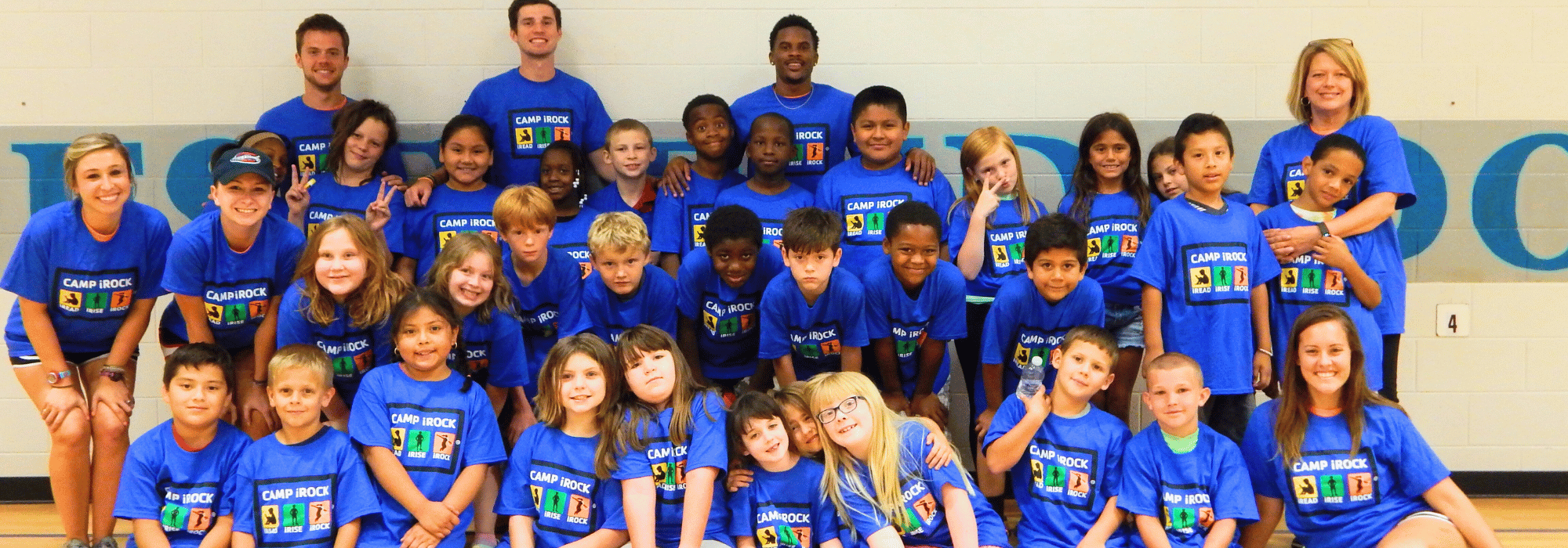 A class of Camp iRock students pose in the gym